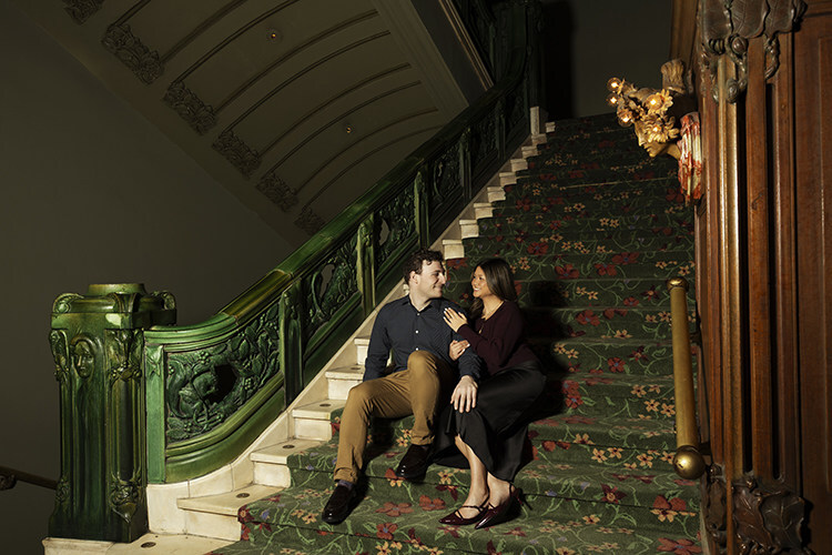 disney theatrical group couple seated on the steps of the new amsterdam theatre